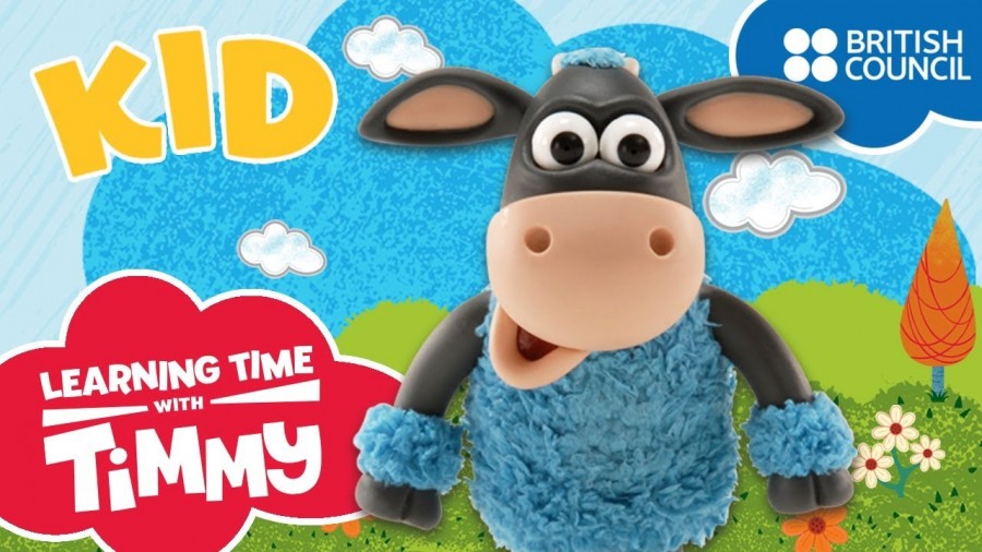 A cheerful cartoon cow with a blue coat and bright blue eyes, perfect for engaging young English learners on YouTube