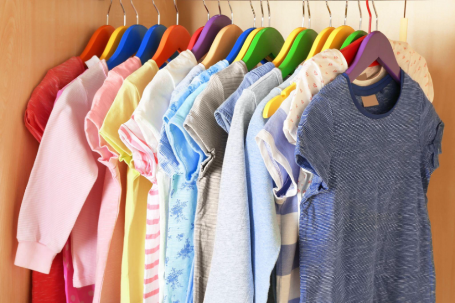 A closet filled with a variety of colorful shirts neatly hanging on hangers