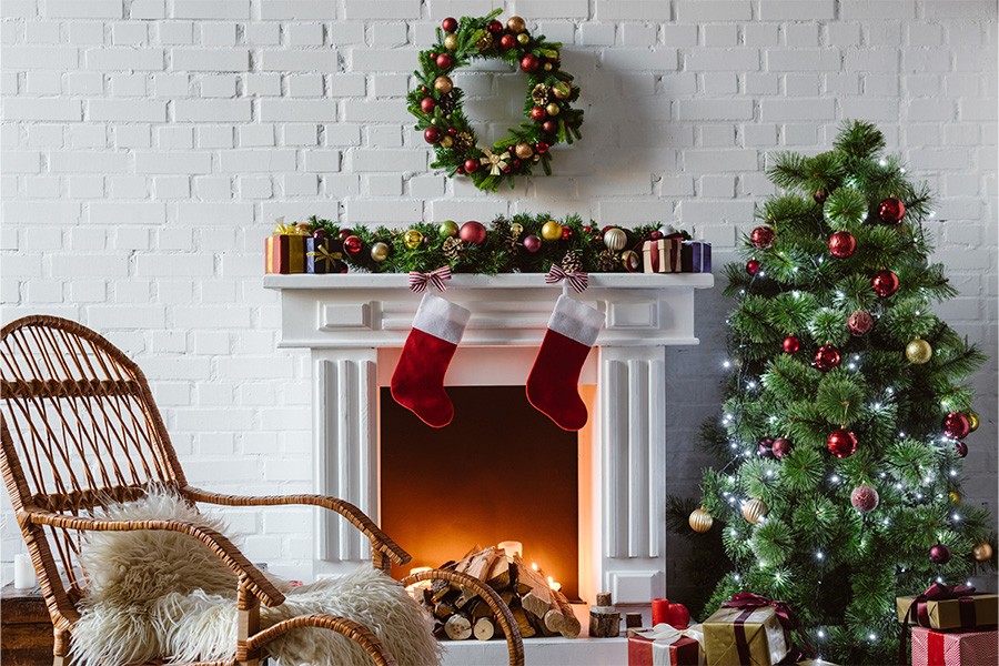 A cozy fireplace adorned with colorful stockings and festive Christmas decorations, creating a magical holiday atmosphere for kids